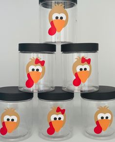 six clear glass containers with cartoon turkey faces on them