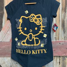 Hello Kitty Cap Sleeve T-Shirt In Black And Gold With Velvet Outline Graphic Nwt. Size Small Bust 32" Length 25" Excellent Condition Unless Otherwise Indicated. Smoke Free Home. Cute Black Stretch T-shirt, Casual Black Hello Kitty Print Top, Y2k Black Hello Kitty Print Top, Black Hello Kitty Print Short Sleeve Top, Fitted Black Hello Kitty Top, Fitted Black Hello Kitty Print Top, Fitted Black Top With Hello Kitty Print, Fitted Short Sleeve T-shirt With Hello Kitty Print, Black Cotton Top With Cat Design