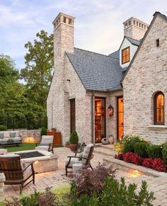 a brick house with an outdoor seating area and fire pit