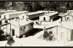 black and white photograph of an old town with many buildings in it's center