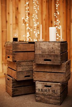 several wooden crates stacked on top of each other in front of a wall with lights