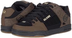 a pair of brown and black shoes with the word globe written on them