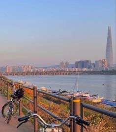 a bike parked on the side of a road next to a body of water