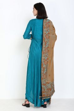 Turquoise angarakha kurta with mirror work and asymmetrical hem. Comes with churidar and embroidered dupatta.
Component: 3
Pattern: Embroidery
Type Of Work: Thread and Mirror
Neckline: V neck
Sleeve Type: Three Fourth
Fabric: Slub Muslin
Color: Blue
Other Details: 
Dupatta with embroidery and tassel detail
Button tabs on the sleeves
Tie up on the side
Occasion: Wedding - Aza Fashions Angarakha Kurta, Muslin Embroidery, Embroidered Dupatta, Pattern Embroidery, Women Kurta, Fashion App, Mirror Work, Churidar, Asymmetrical Hem