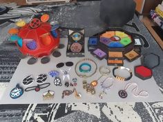 a table topped with lots of assorted items on top of a carpeted floor