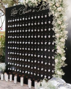 a black and white wedding backdrop with lots of earrings on it