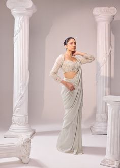 An exquisit Italian imported fabric being the key highlight of this ensemble which is sure to never go out of trend. An artistic symphony of fine aari embroidery adorns the blouse with full sleeves. It has 3D katdana loops, this unreal detailing enhance the ethreal look of the outfit. Colour: Glacier Gray Material: Italian - Saree, Organza- Blouse No of components: 2 Surface Ornamentation: Hand Embroidery Care Instructions: Dry Clean Shipping Time: 3-4 weeks Blouse With Full Sleeves, Surface Ornamentation, Saree Organza, Organza Blouse, Shirt Jacket Men, Drape Saree, Aari Embroidery, Silk Roses, Co Ord Set