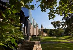 the building is surrounded by trees and grass