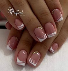 a woman's hands with pink and white nail polishes on their nails, holding a manicure