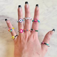 These cute, colorful rings are the perfect accessories to stack, fidget with and show off! HIGHLIGHTS: ⭐️ Cute stackable rings  ⭐️ High-quality & durable ⭐️ One-of-a-kind, unique design ⭐️ Includes FREE GIFTS! ⭐️ Handmade with PLUR ⭐️ Eco-friendly packaging & shipping Everything in my shop is hand-made and are all original designs! Made with high-quality beads, thick elastic jewelry string (1.2mm), and triple-knotted, ensures the best stretch and durability without drying out over time.  Supporting my small business means the world to me so as a thank you to my amazing customers, every order also includes free gifts! (Bigger orders = bigger gifts 😊) Please note- all of my items are hand-made and unique, so they may not look the exact same as the photos.  If you have any questions, want to Seed Bead Rings, Elastic Jewelry, Stretch Rings, Colorful Rings, Bead Rings, Kandi Cuff, Stackable Ring Sets, Rave Accessories, Cuff Bracelets Handmade