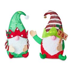 two christmas gnomes are standing next to each other on a white background, one is holding a sign and the other has a green hat