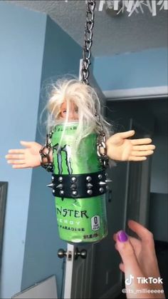 a doll hanging from a metal chain with chains attached to it's arms and head