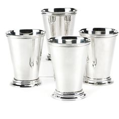 four silver cups are shown on a white background