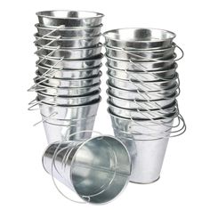 several metal buckets stacked on top of each other with one empty cup in the middle