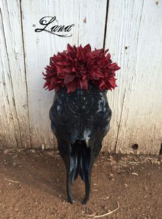 an animal skull with flowers on its head