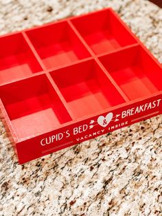 a red cup's bed breakfast box sitting on top of a granite countertop