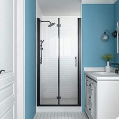 a bathroom with blue walls and white tile flooring, including a walk in shower