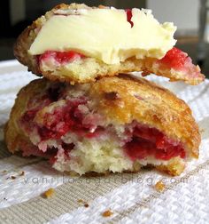 two pastries sitting on top of each other with cream and strawberries in them