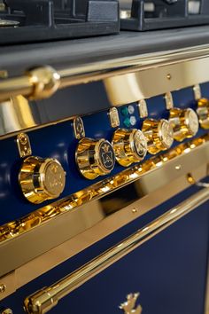 an oven with gold trim and knobs on it