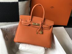 Description HRMS Birkin Orange Togo Gold Hardware Bag For Women, Handbags, Shoulder Bags 30cm/12in Rep 1:1 Size: 30 x 23 x 17 cm / 12 x 9 x 6.5 inches (Length x Height x Width) Hermès bags are considered the ultimate luxury item the world over. Hand stitched by skilled craftsmen, wait lists of a year or more are common. This Birkin has tonal stitching, a front toggle closure, a clochette with lock and two keys, and double rolled handles. This bag is also known to hold the shape of the bag well o Hermes Birkin Orange, Hermes Birkin 30, Togo Leather, Hermes Handbags, Orange Bag, Orange Leather, Hermes Bags, Hermes Bag, Bag For Women