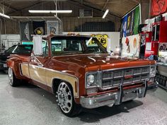 an orange and brown truck parked in a garage