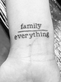 a black and white photo of a wrist tattoo with the words family everything on it