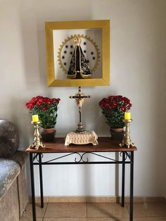 a small table with flowers on it and a cross in the middle next to it