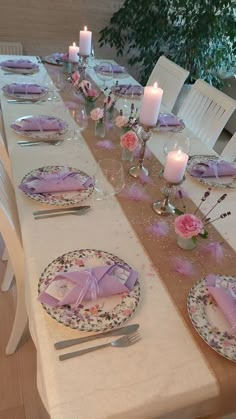 the table is set with plates, napkins, and candles for an elegant dinner