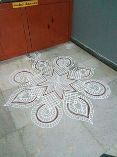 an intricately designed floor in the middle of a room with cabinets and cupboards