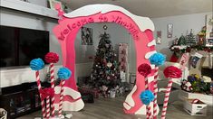 a decorated christmas tree in the corner of a room with candy canes and decorations