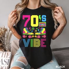 70's Vibe Shirt,Retro 70's Shirt, Comfort Colors,Vintage 1970's Shirt,70th Birthday Shirt, Casette Lover Shirt,70's Vibe Party Shirt,1576 COMFORT COLORS - ADULT UNISEX - SHORT SLEEVE T-SHIRT - 1717 6.1 oz./yd² (US), 10 oz/L yd (CA), 100% ring-spun cotton, 30 singles Garment dyed for that lived in feel and almost no shrinkage at home. Soft ring-spun cotton fabric with 100% cotton threads Relaxed fit Topstitched, classic width, rib collar Shoulder to shoulder twill tape Signature twill label Made With Respect Proud member of the U.S. Cotton Trust Protocol Made with OEKO-TEX certified low-impact dyes Our clean pigment dye colors are salt free This product meets the following Sustainable Style subcategories: Sustainable Manufacturing  Socially Conscious Manufacturing Shade variations are inher Vintage Graphic Print Party Tops, Retro Graphic Print Party Tops, Retro Party Tops With Graphic Print, Retro Graphic Print Tops For Party, Vintage Letter Print Tops For Party, Vintage Party Tops With Letter Print, Retro Letter Print Tops For Birthday, Retro Short Sleeve Top For Birthday, 70th Birthday Shirt