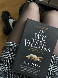 a book sitting on top of a woman's legs