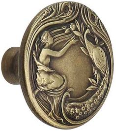 an antique style door knob with a mermaid on it