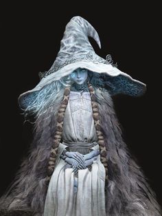 a woman dressed as a wizard with long hair and a large hat on her head