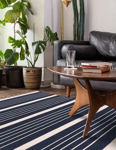 a living room filled with furniture and plants