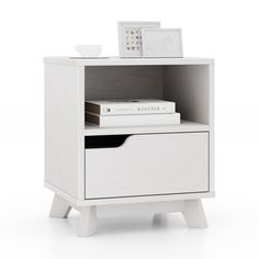 a white nightstand with two drawers and a book on the bottom shelf next to it