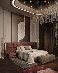 a bedroom with a large bed and chandelier hanging from the ceiling