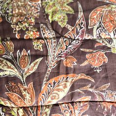 an orange and brown floral print fabric