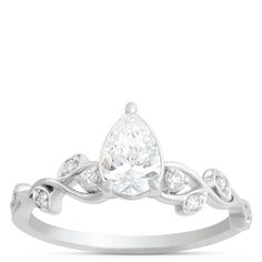 a pear shaped diamond ring with leaves on the band