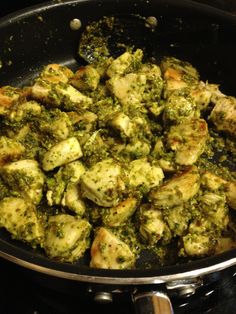 broccoli and chicken are being cooked in a skillet