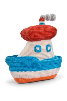 a knitted toy boat with a red and white top on it's head