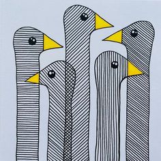 three birds standing next to each other on top of a white sheet with black and yellow lines