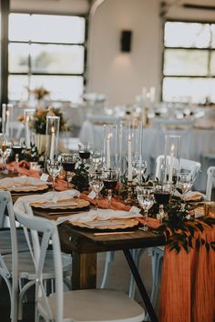 the table is set with wine glasses and place settings for an elegant dinner or reception