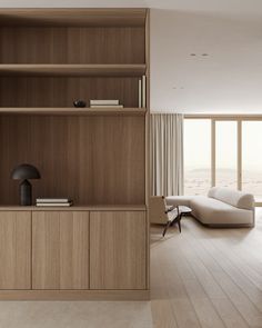 a living room filled with furniture next to a large open window on top of a hard wood floor