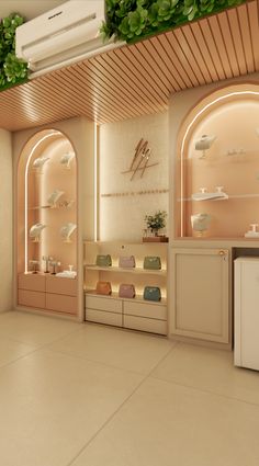 the interior of a jewelry store with green plants growing on the ceiling and shelves above