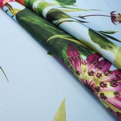 three different types of wrapping paper with flowers on them, one is green and the other is pink