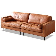 a brown leather couch sitting on top of a white floor