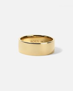 a yellow gold wedding ring with the word roen on it