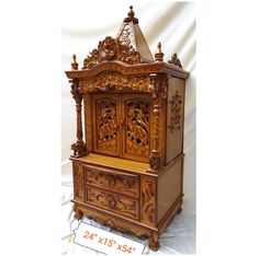 an ornate wooden cabinet with carvings on the front and sides, is shown against a white background