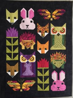 a quilted wall hanging with many different animals on it